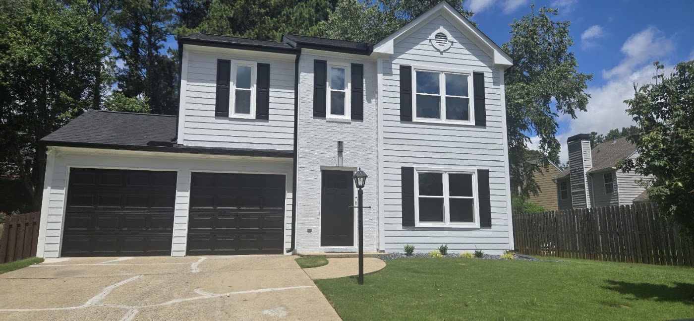Dark gutters on a gray two-story